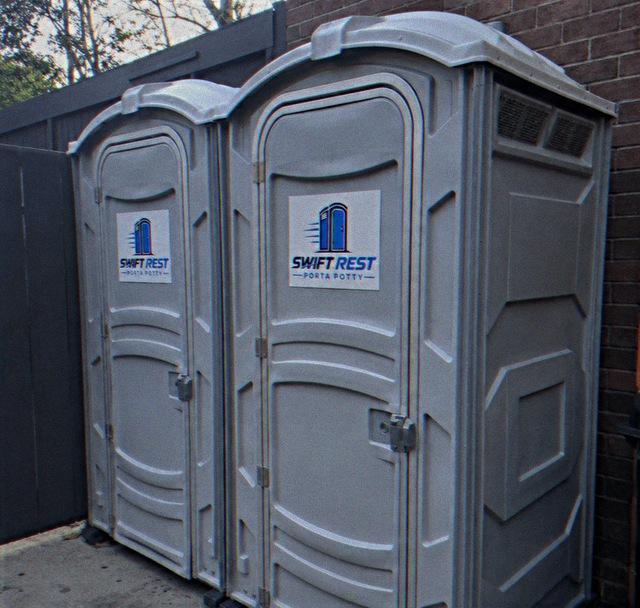 Pair of deluxe portable restrooms positioned for event guests