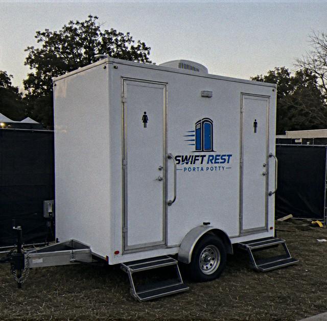 Luxury restroom trailer rental parked at an outdoor event