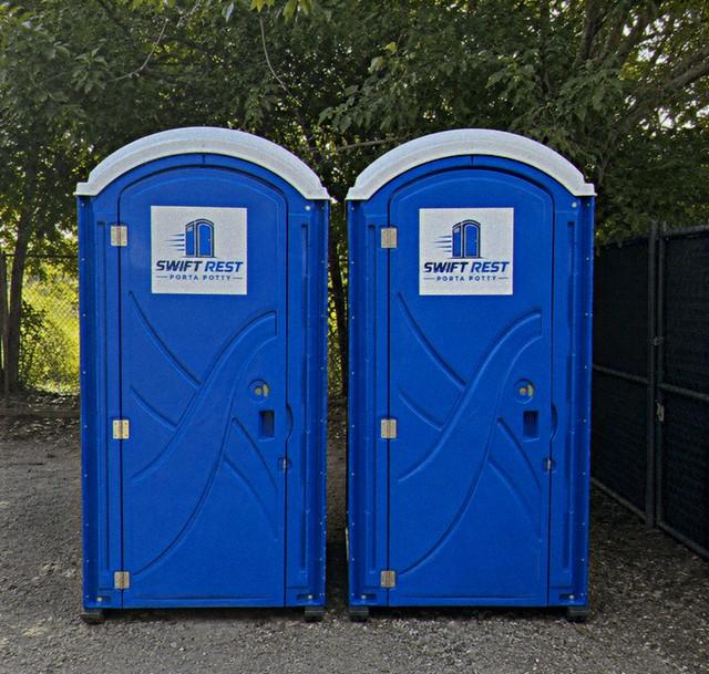 Portable restroom unit set up and ready for use on a job site