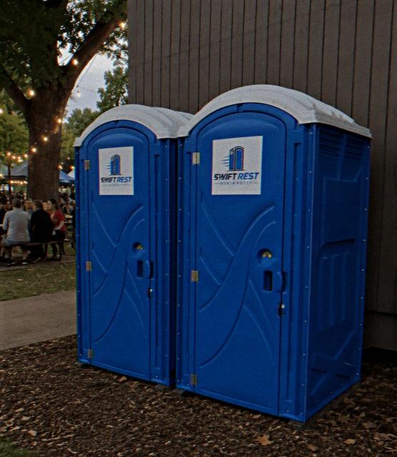 Portable toilet rental positioned at the edge of a work area